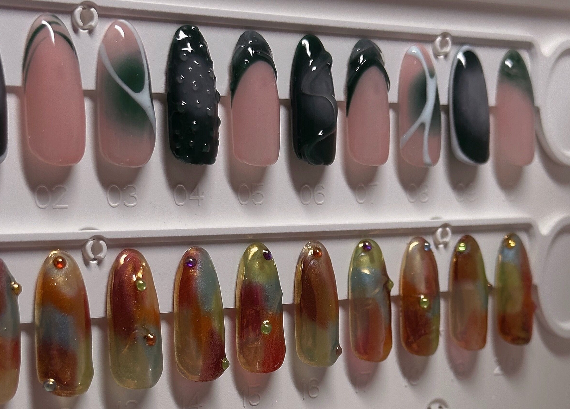 Nail art display at The Sulking Room, Horsham, England, GB; elegant designs with vibrant colors.