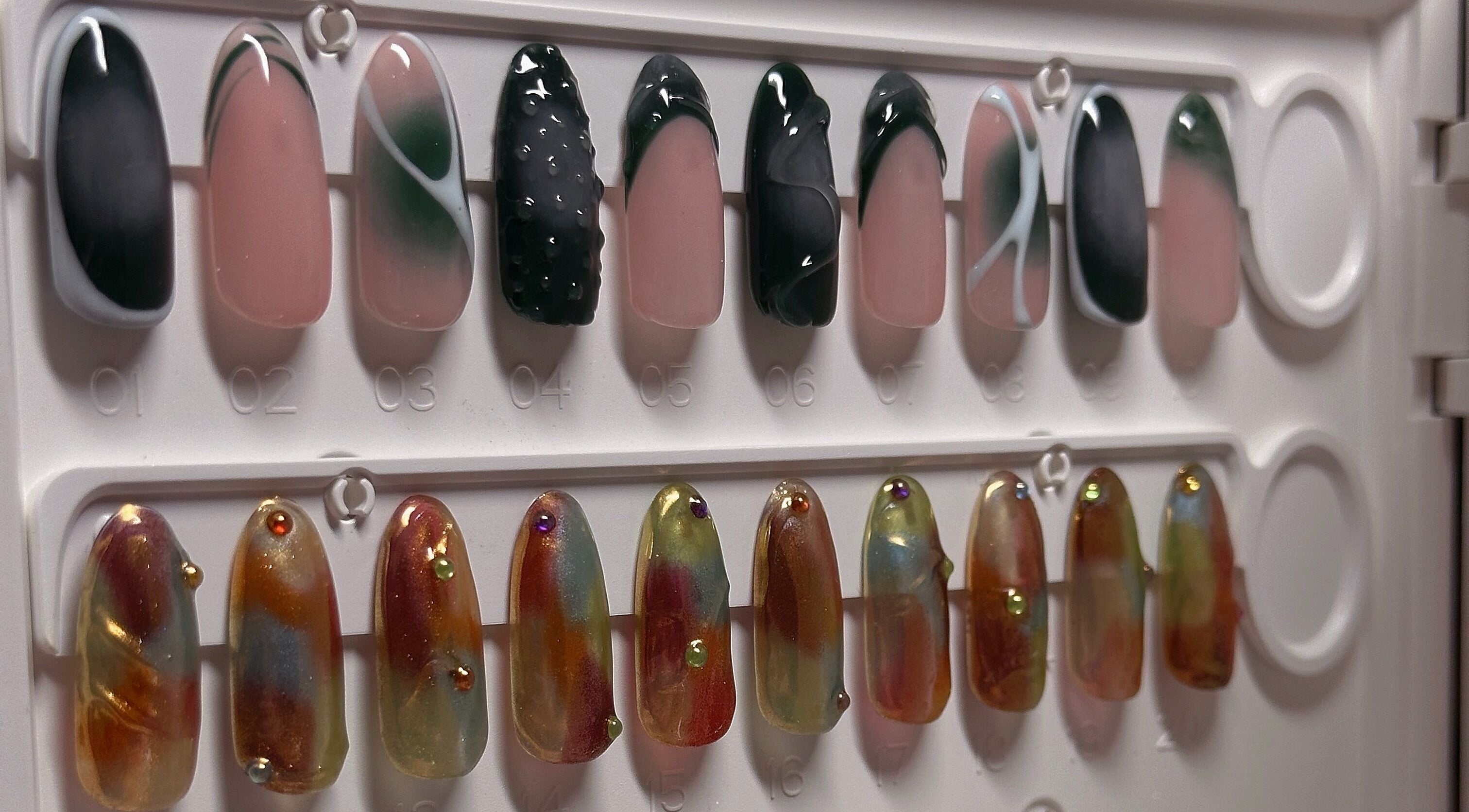 Nail art display at The Sulking Room, Horsham, England, GB; elegant designs with vibrant colors.