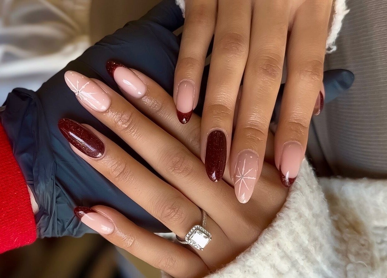 Stylish nail design at The Sulking Room, Horsham, England, GB, showcasing elegant burgundy and pink art.