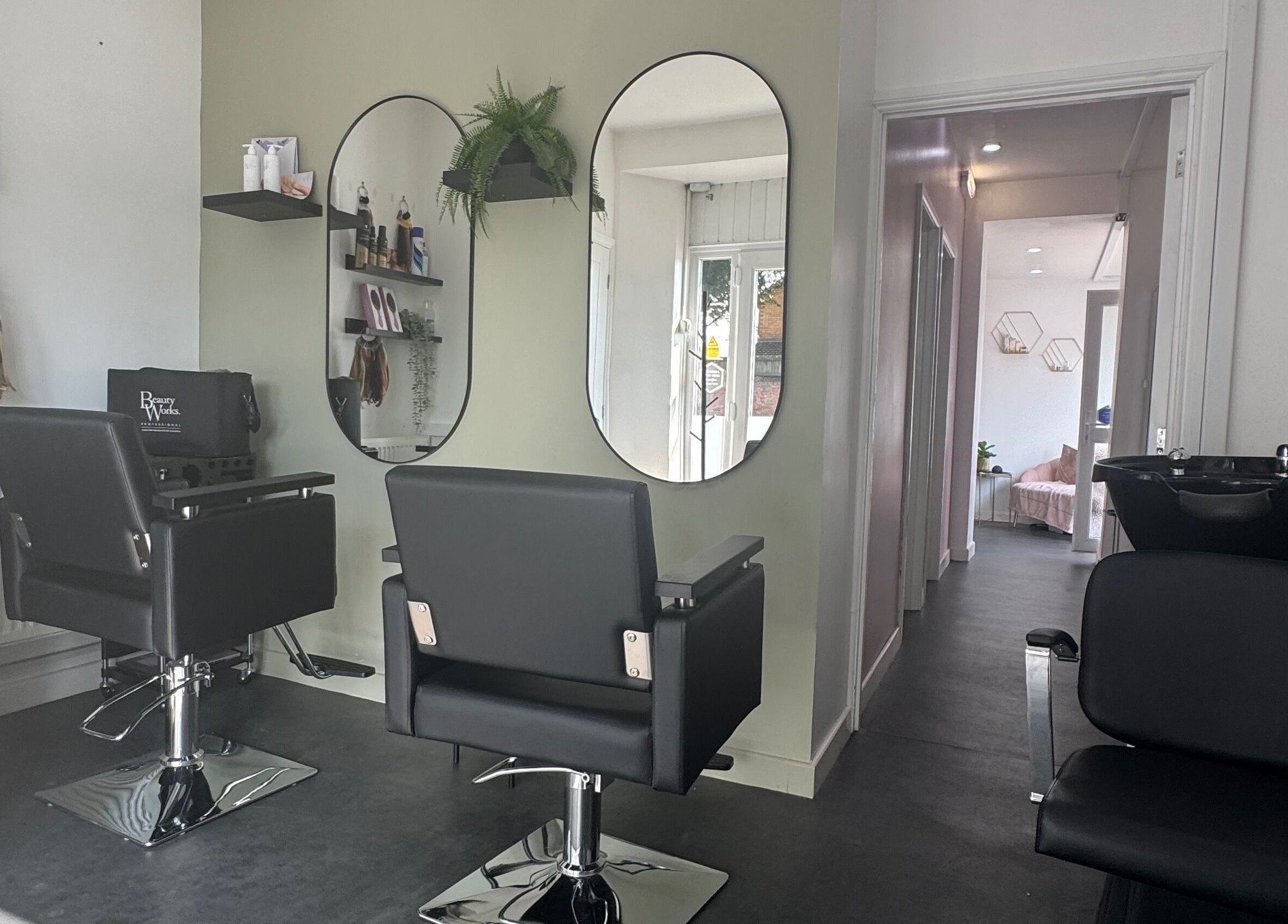 Modern salon interior at Platinum HQ, Caerphilly, Wales, GB with sleek chairs and mirrors.