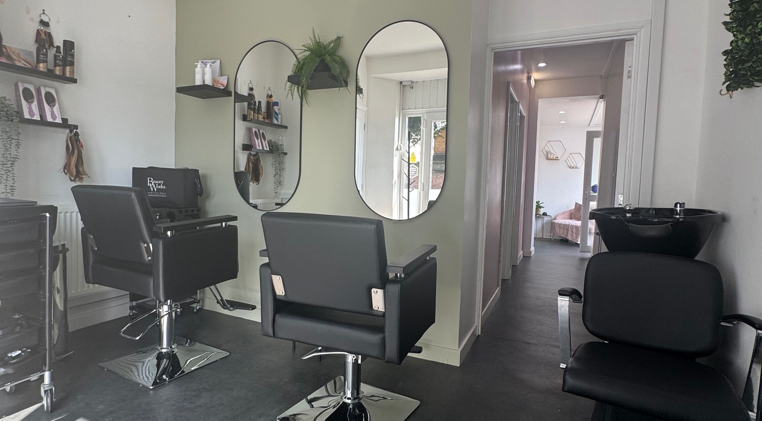 Modern salon interior at Platinum HQ, Caerphilly, Wales, GB with sleek chairs and mirrors.