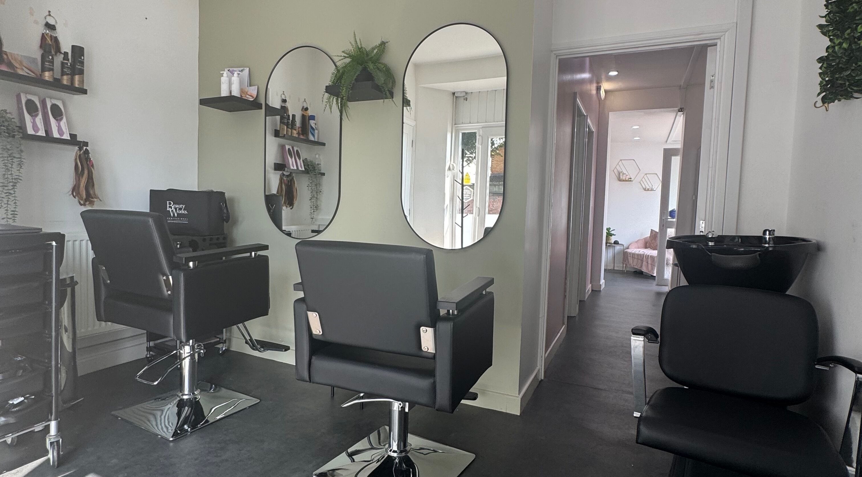 Modern salon interior at Platinum HQ, Caerphilly, Wales, GB with sleek chairs and mirrors.