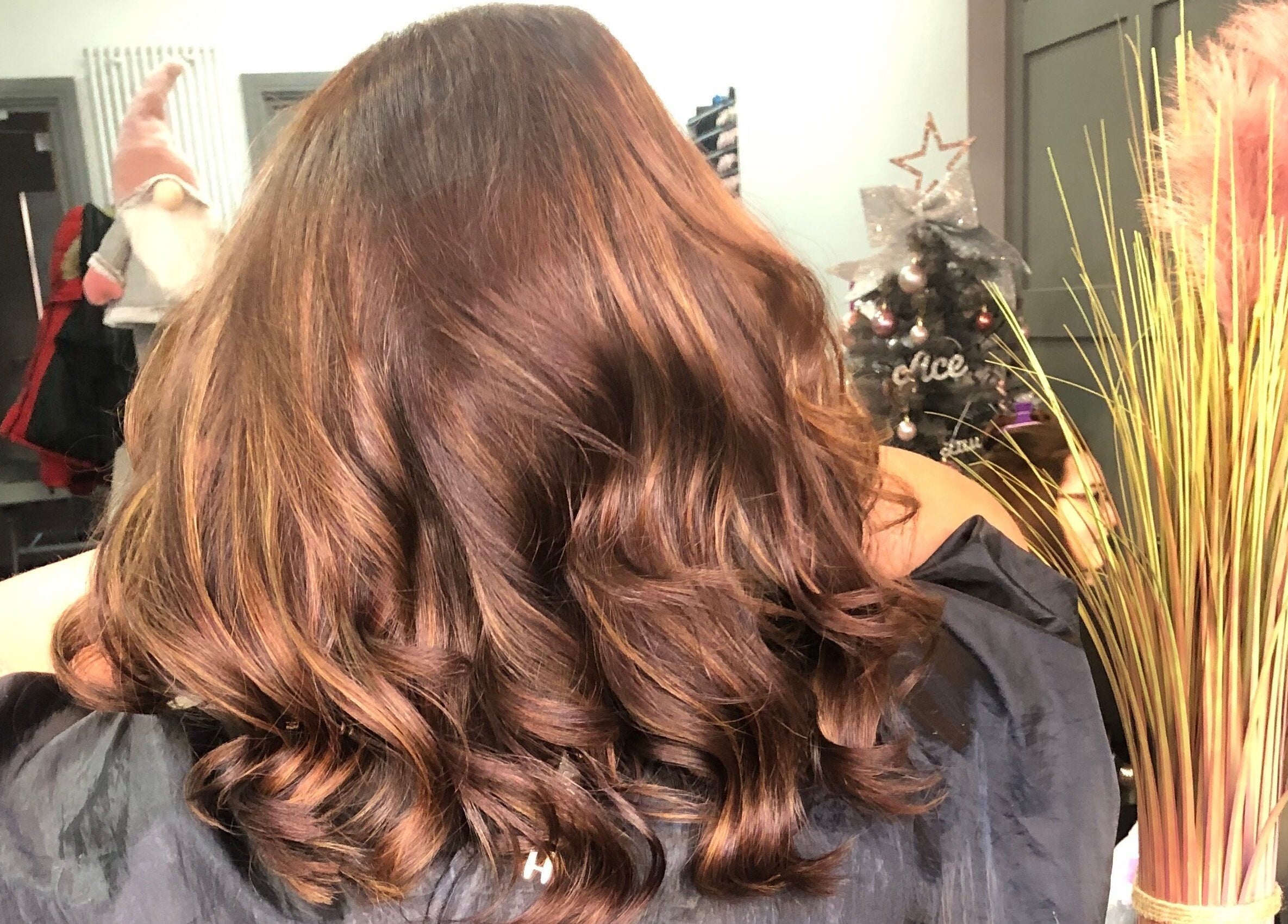 Lustrous wavy hair styled at Platinum HQ, Caerphilly, Wales, GB, showcasing vibrant brown tones.