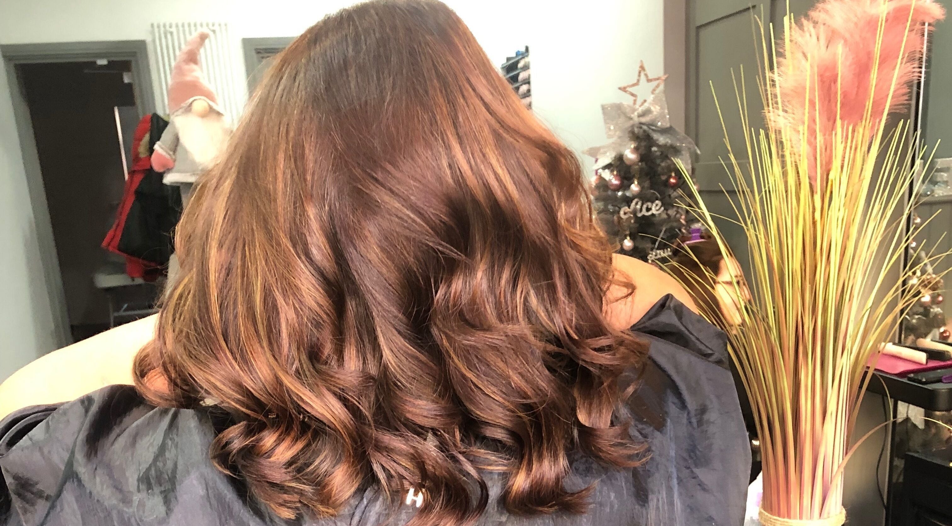 Lustrous wavy hair styled at Platinum HQ, Caerphilly, Wales, GB, showcasing vibrant brown tones.