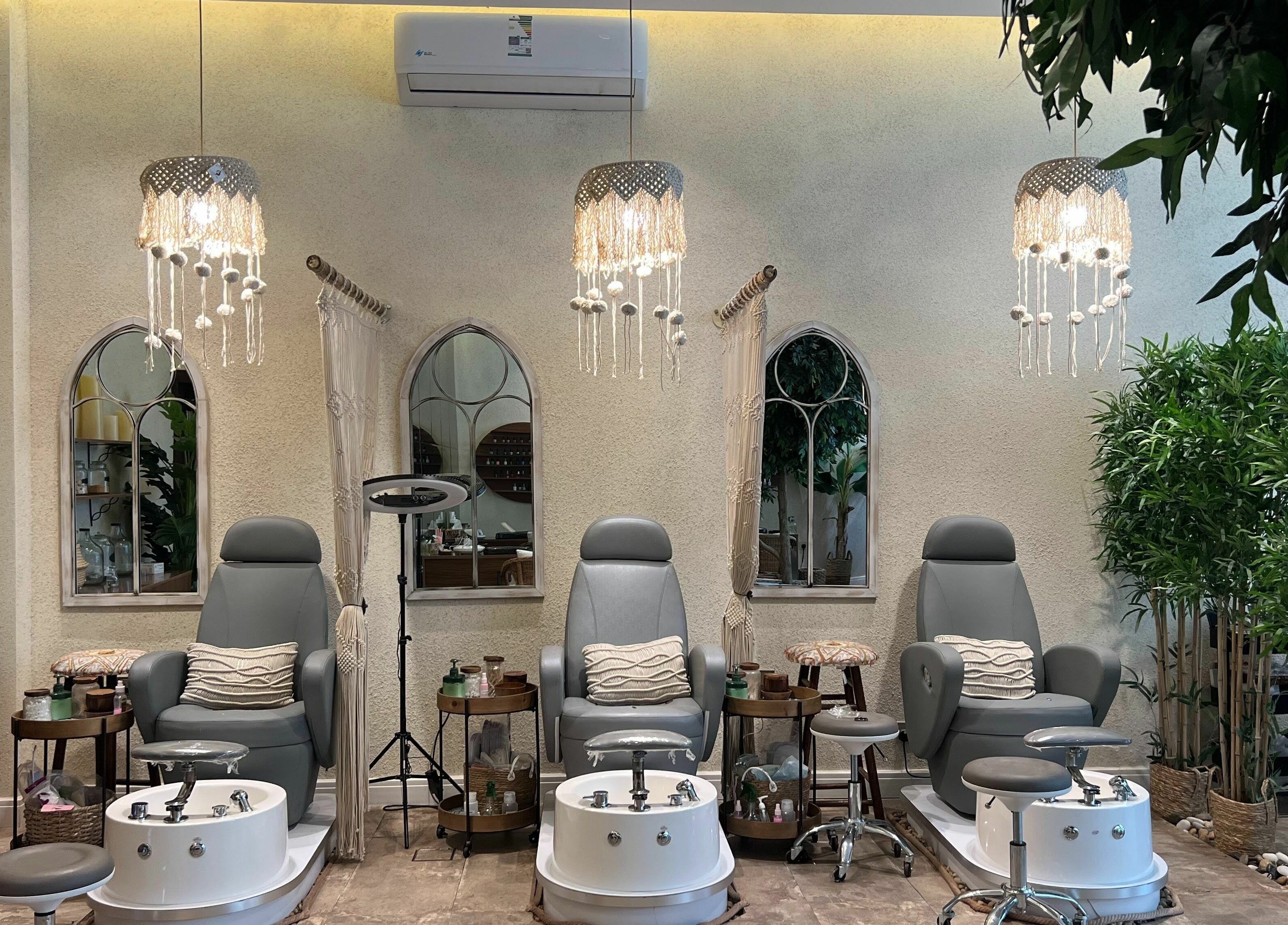 Cozy pedicure stations at Nails Oasis | واحة الاظافر, الرياض, منطقة الرياض, SA, under elegant chandeliers.