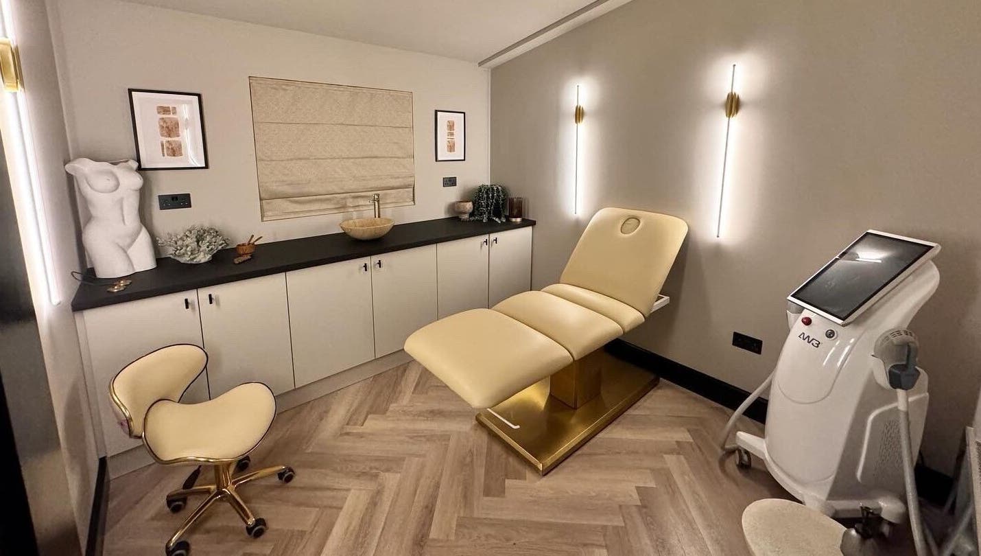 Modern treatment room at Antoinette Aesthetics, East Harling, England, showcasing elegant decor and equipment.