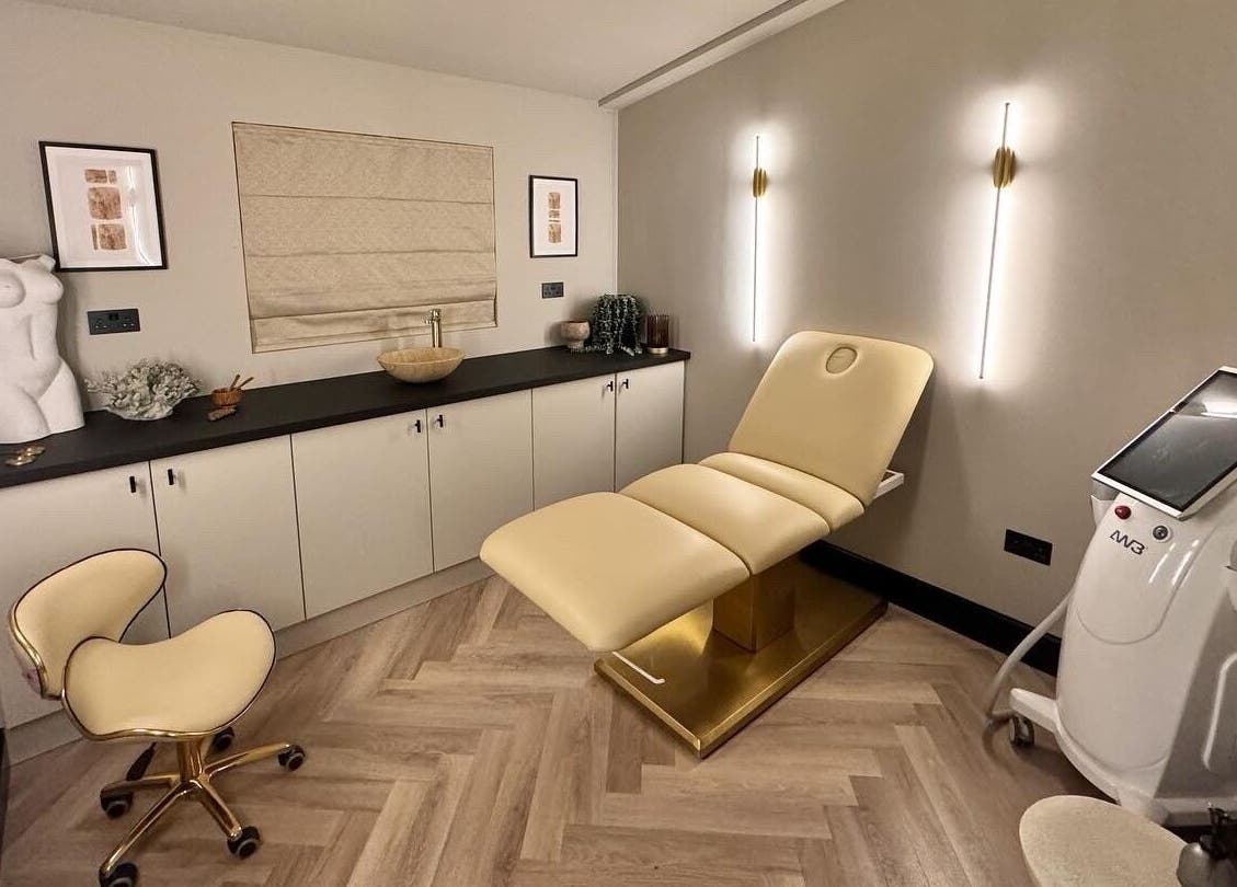 Modern treatment room at Antoinette Aesthetics, East Harling, England, showcasing elegant decor and equipment.