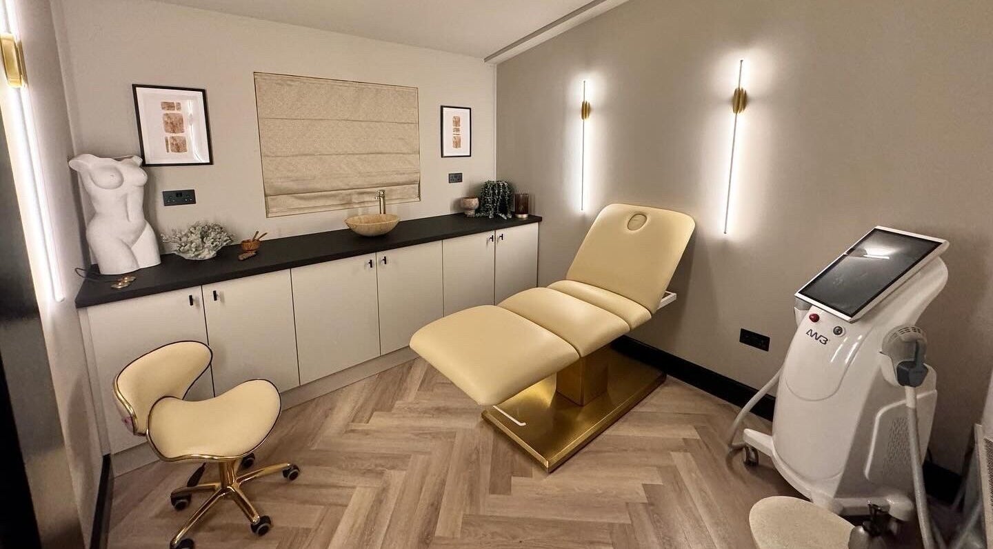 Modern treatment room at Antoinette Aesthetics, East Harling, England, showcasing elegant decor and equipment.