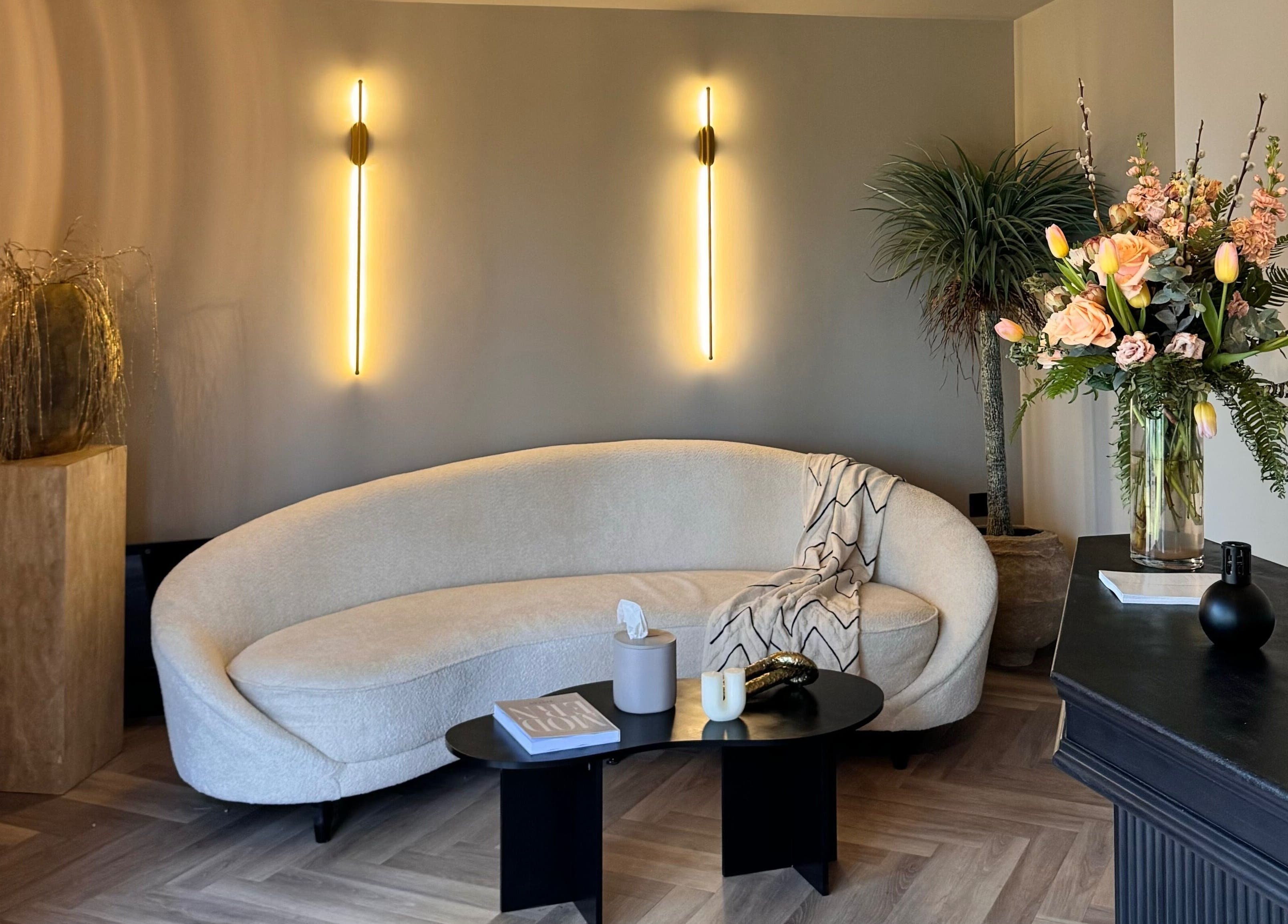Elegant lounge at Antoinette Aesthetics, East Harling, England, GB with chic decor and ambient lighting.