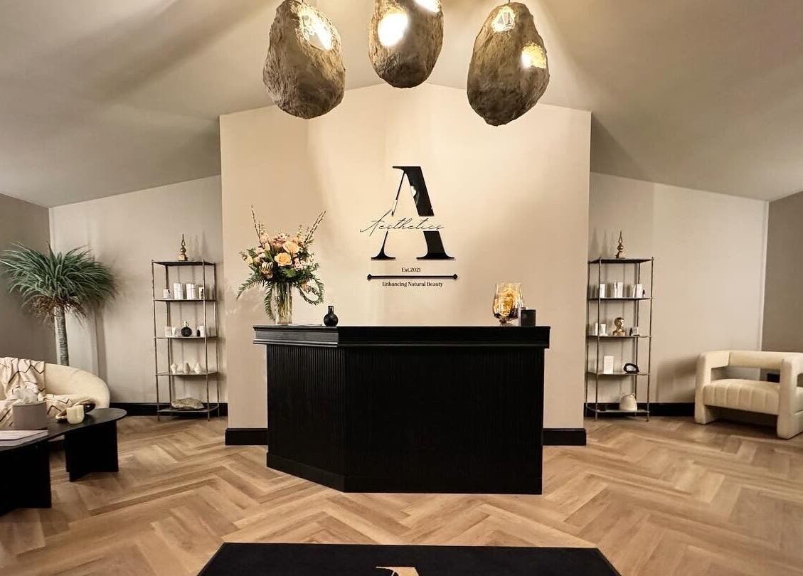 Reception area at Antoinette Aesthetics, East Harling, England, GB, with modern decor and soft lighting.