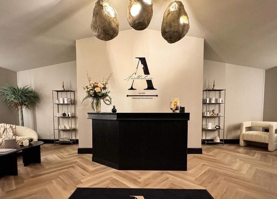 Reception area at Antoinette Aesthetics, East Harling, England, GB, with modern decor and soft lighting.