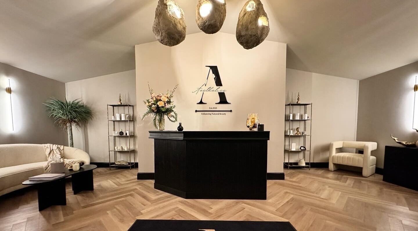 Reception area at Antoinette Aesthetics, East Harling, England, GB, with modern decor and soft lighting.