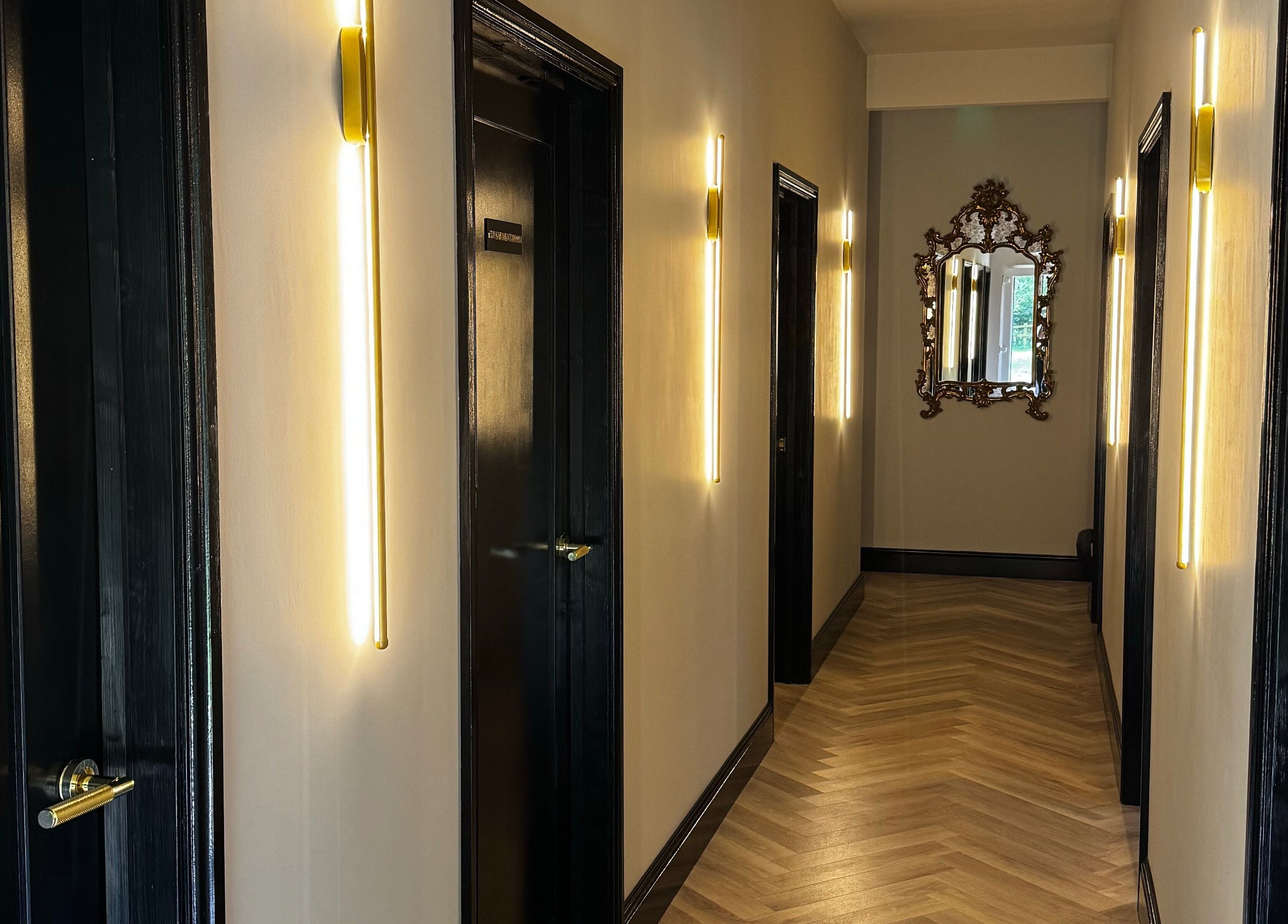 Illuminated hallway at Antoinette Aesthetics, East Harling, England, GB, showcasing elegant decor and warm lighting.