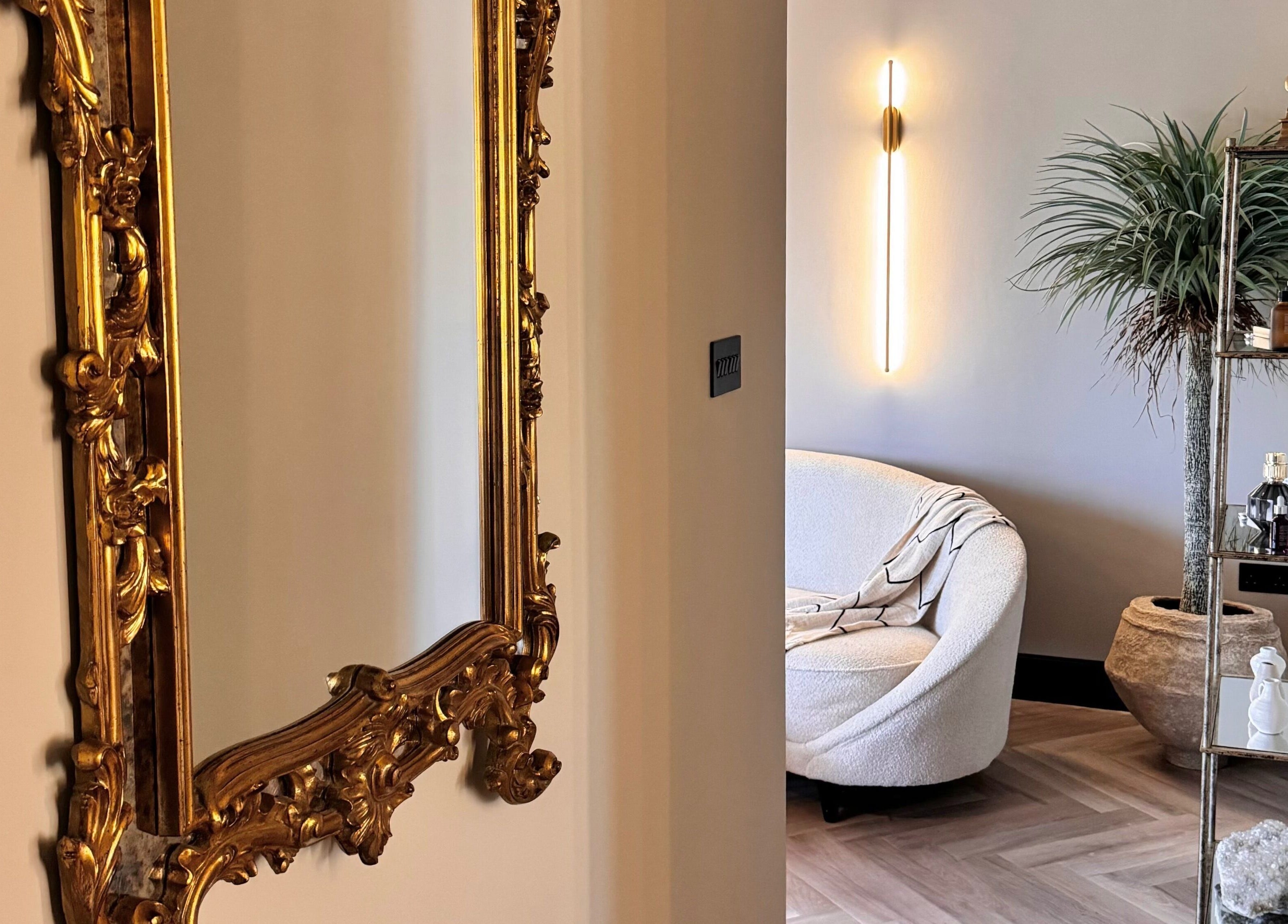 Luxurious interior with ornate mirror and cozy seating at Antoinette Aesthetics, East Harling, England, GB.