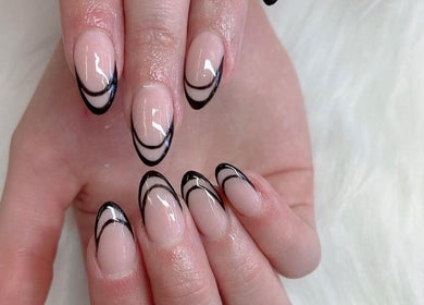 Chic black tipped manicure at TK Nails and Beauty (Rosanna), Melbourne, Victoria, AU on white fur background.