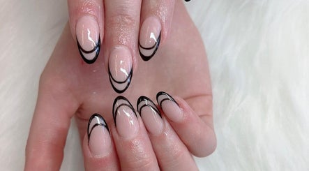 Chic black tipped manicure at TK Nails and Beauty (Rosanna), Melbourne, Victoria, AU on white fur background.