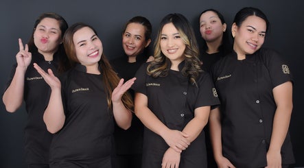 Friendly staff of Glow & Grace - Home Service in Riyadh, SA, smiling in uniform.