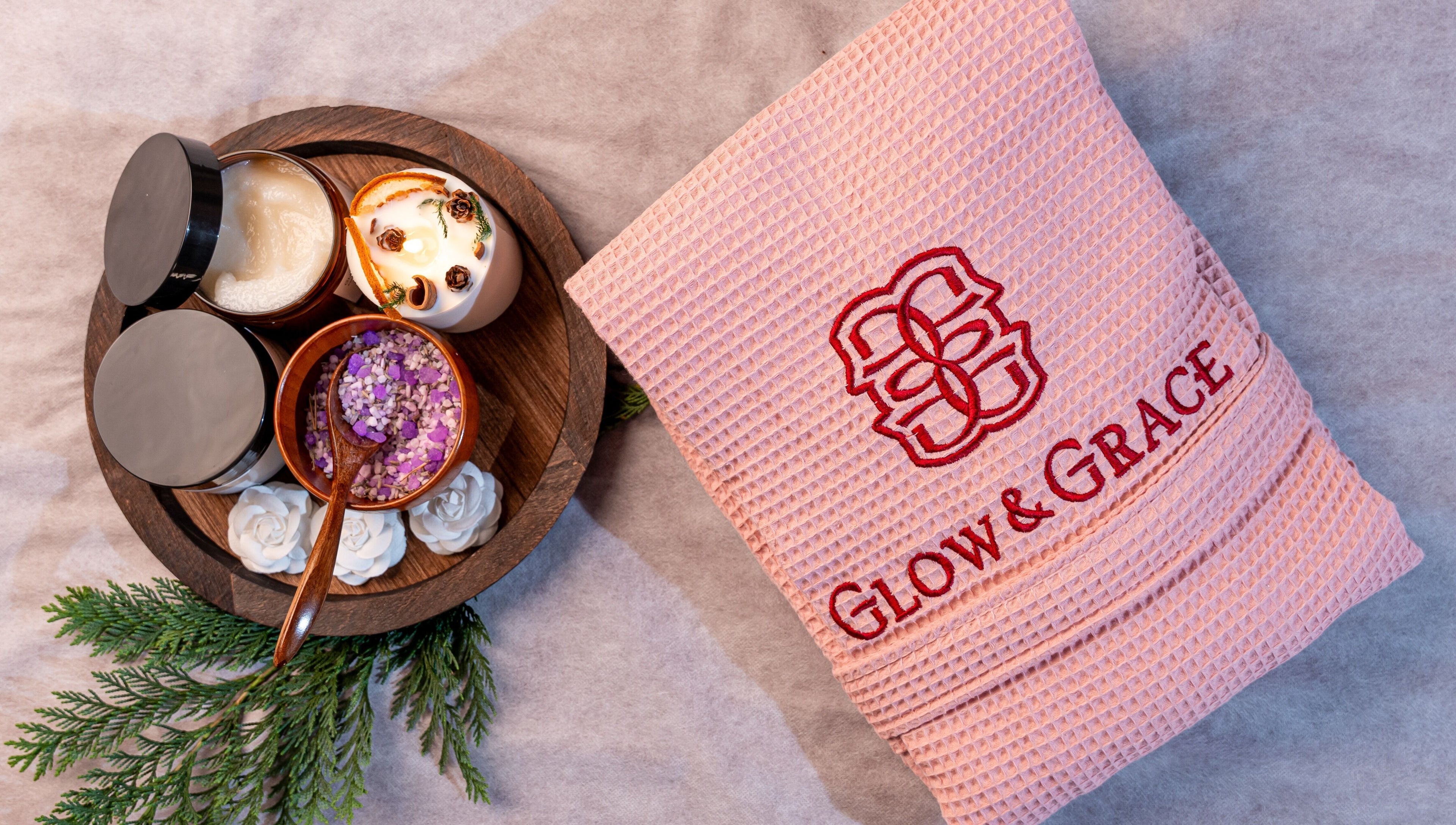 Spa essentials set at Glow & Grace - Home Service Riyadh, Riyadh, SA featuring towel, scrub, and candle.