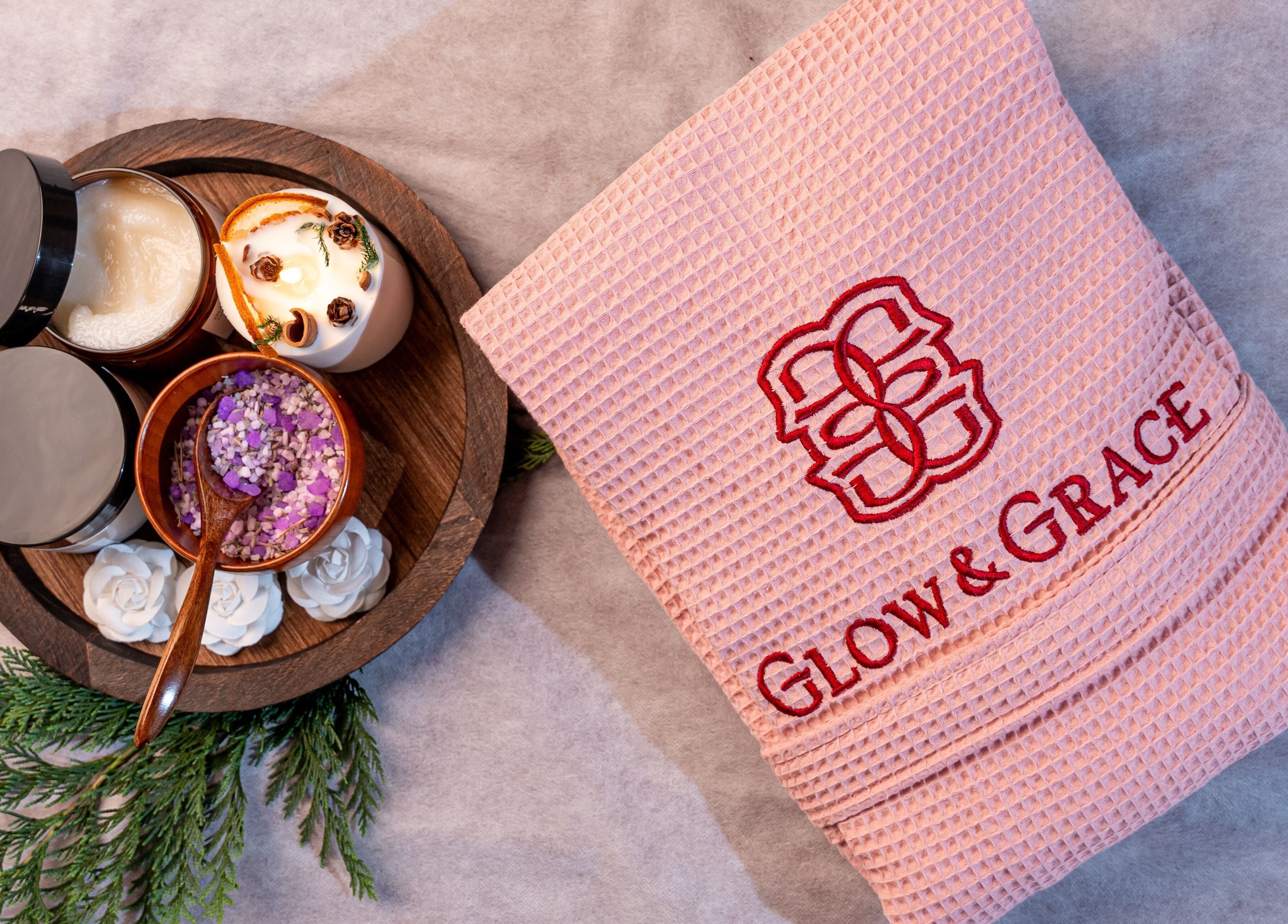 Spa essentials set at Glow & Grace - Home Service Riyadh, Riyadh, SA featuring towel, scrub, and candle.