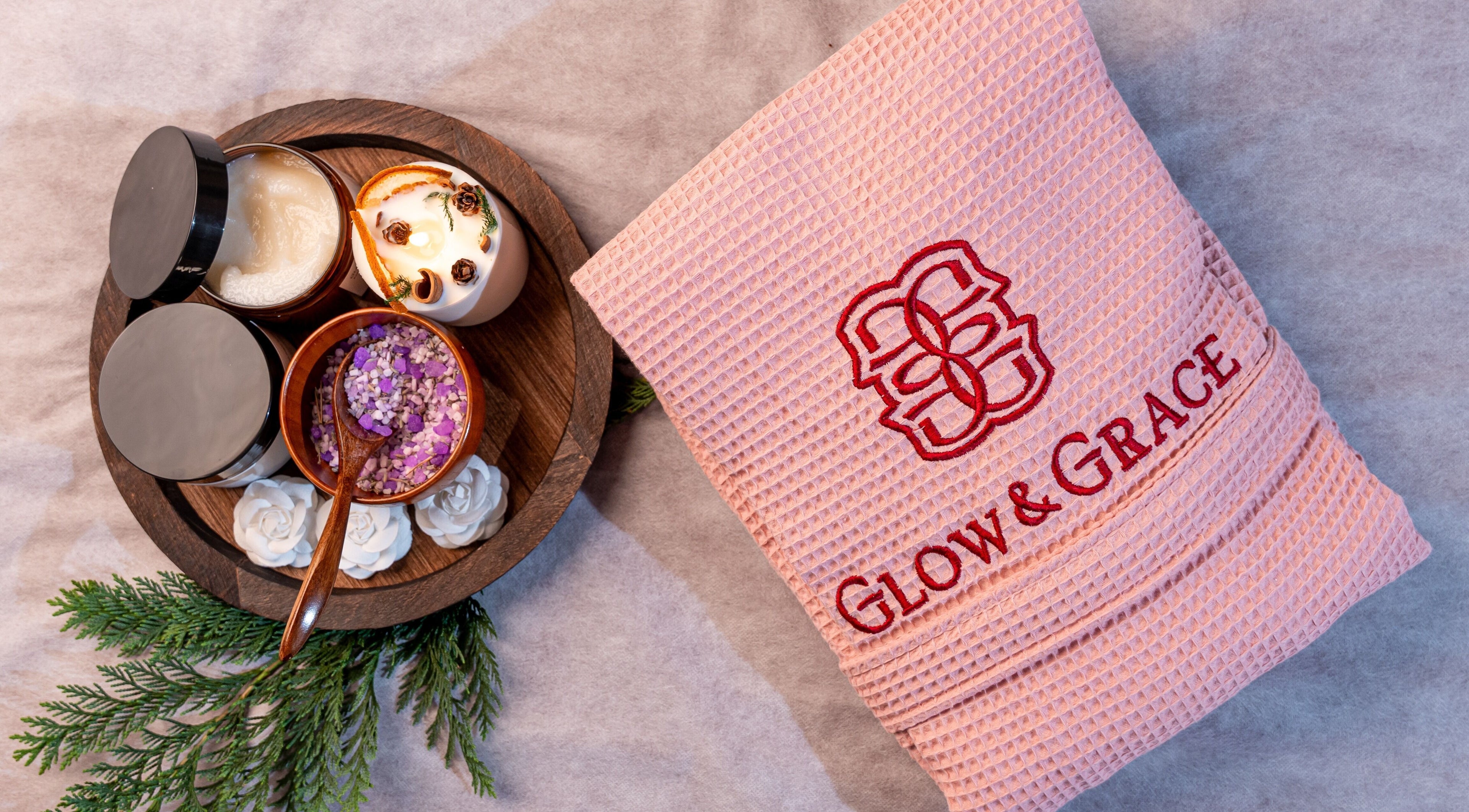 Spa essentials set at Glow & Grace - Home Service Riyadh, Riyadh, SA featuring towel, scrub, and candle.