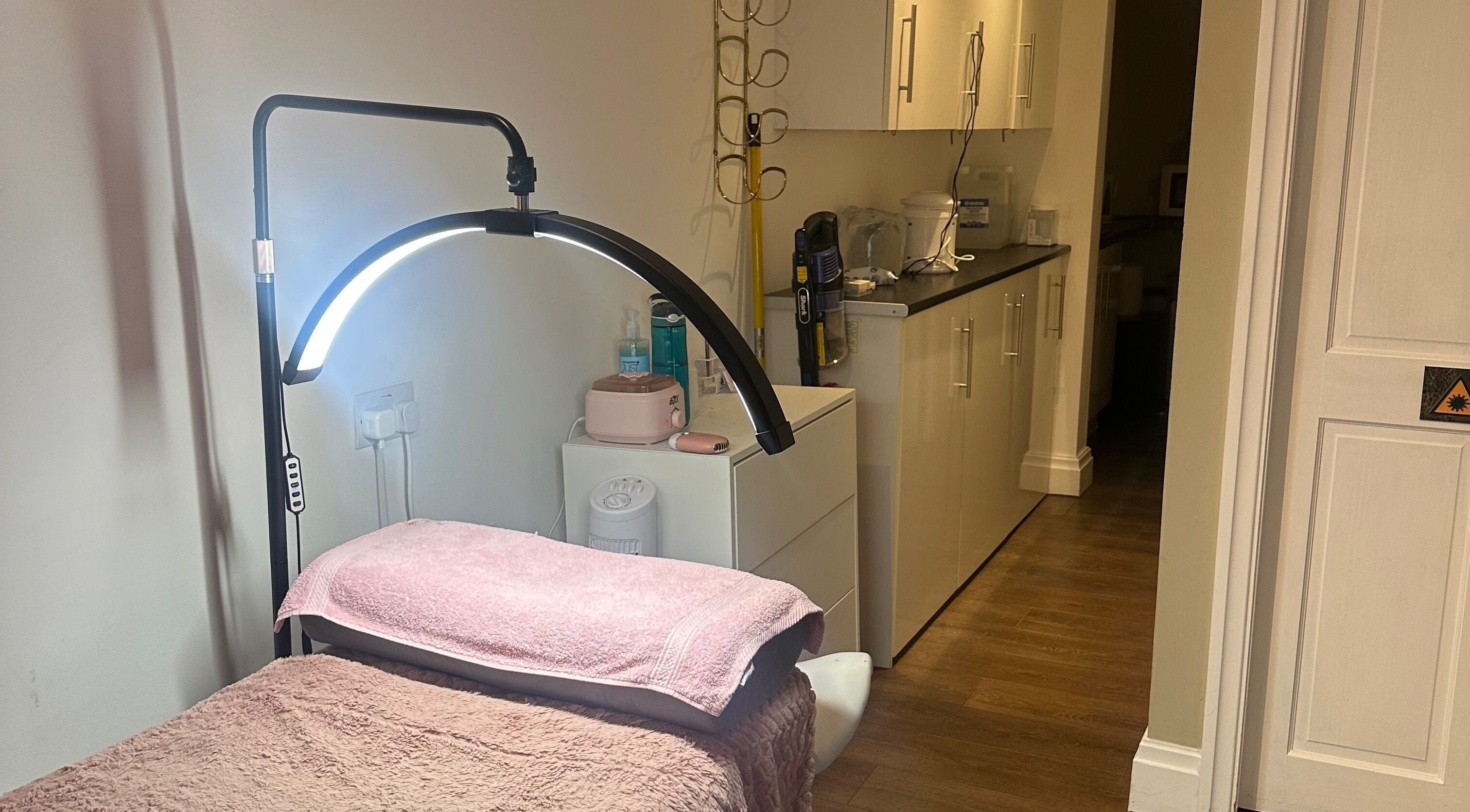 Cozy spa room at Kwbeauty, Earby, England, GB, featuring a plush treatment bed and soft lighting.