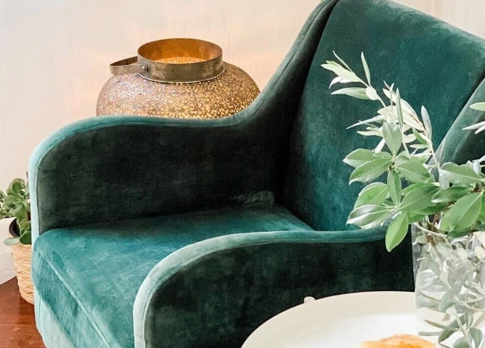 Cozy green armchair with plant decor at Elements Bodyworks, Doubleview, Western Australia, AU.