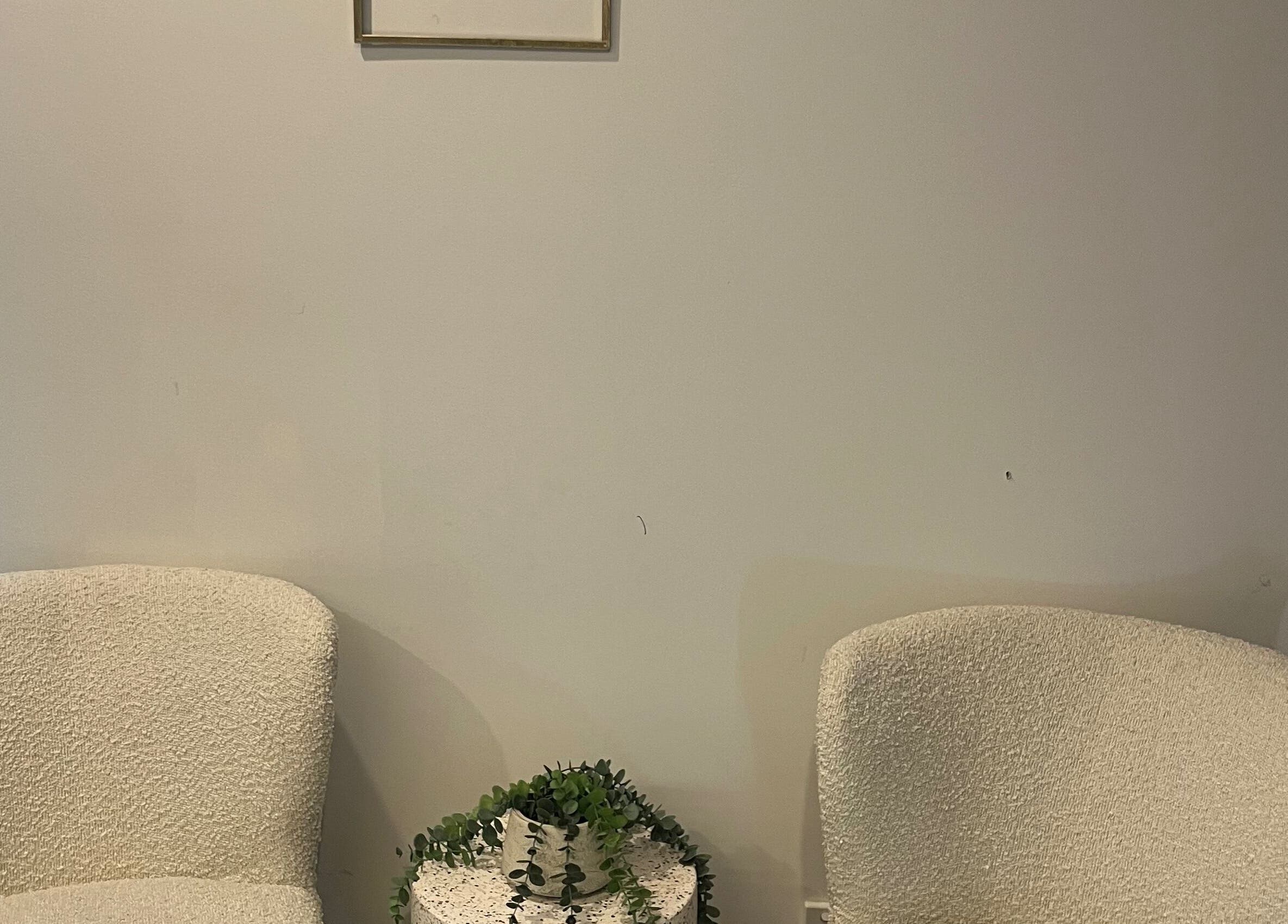 Cozy seating area with white chairs at Stef’s Vogue Beauty, Gregory Hills, New South Wales, AU.