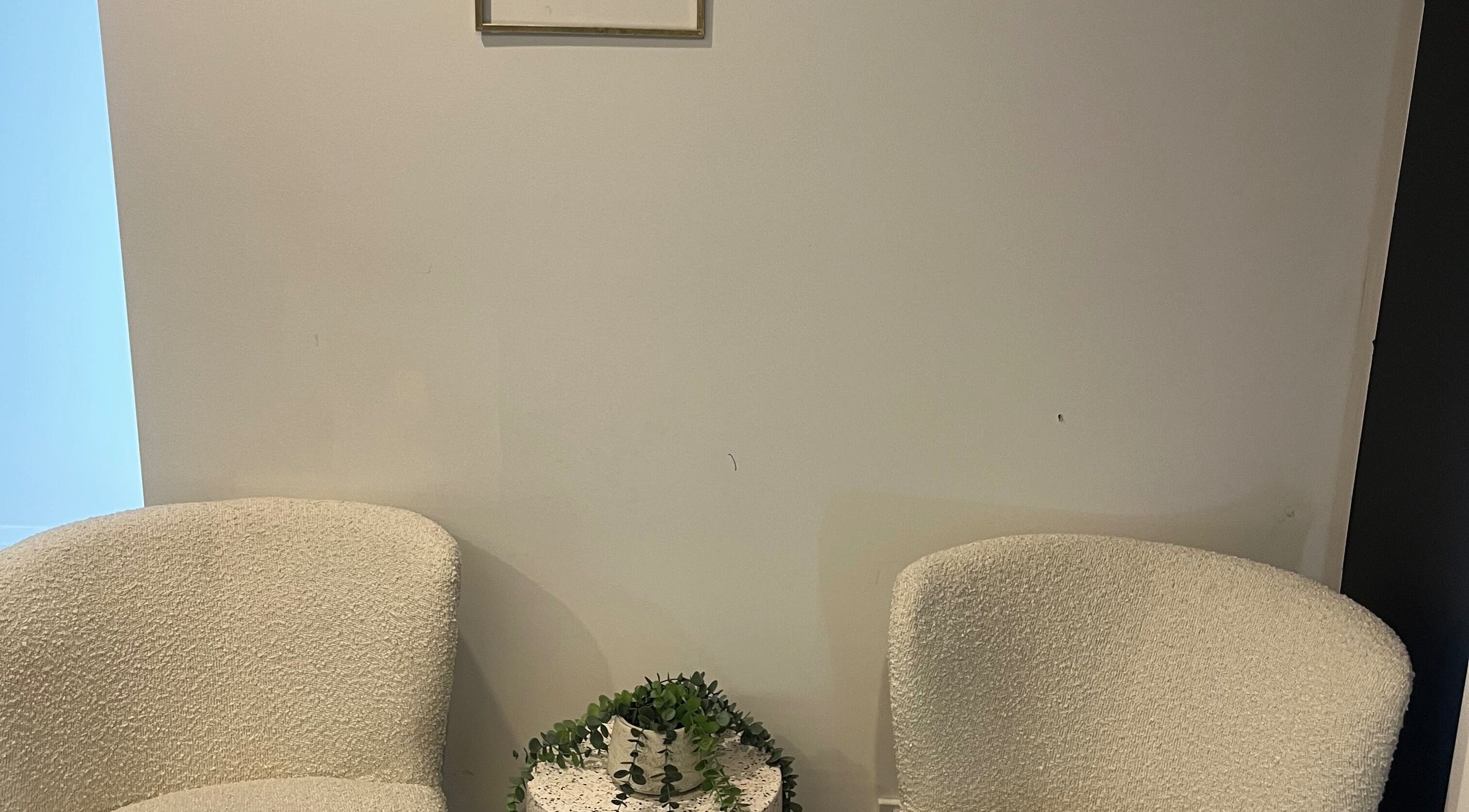 Cozy seating area with white chairs at Stef’s Vogue Beauty, Gregory Hills, New South Wales, AU.