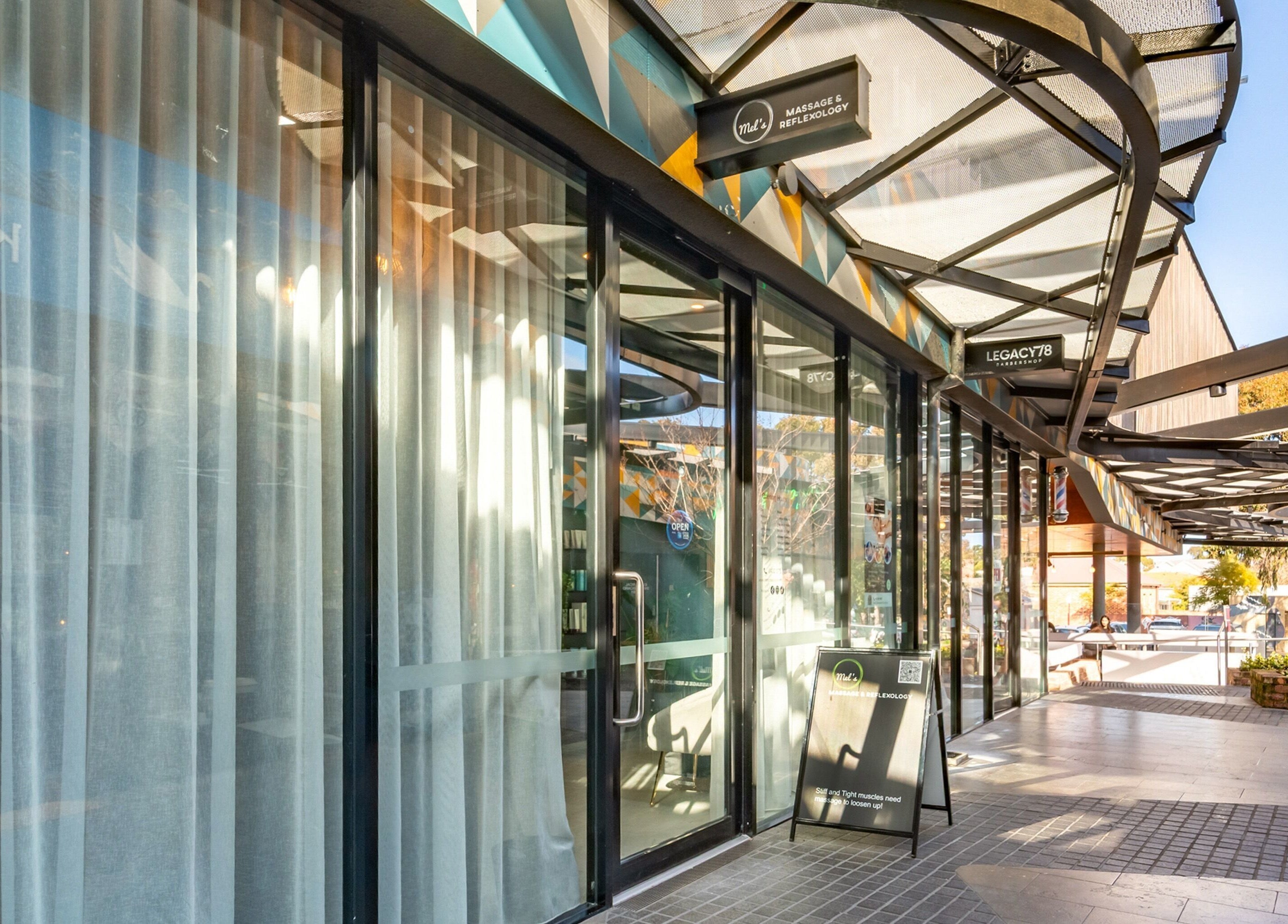 Entrance of Mel's Massage & Reflexology - Mount Lawley, featuring glass doors and outdoor view in Mount Lawley, Western Australia, AU.