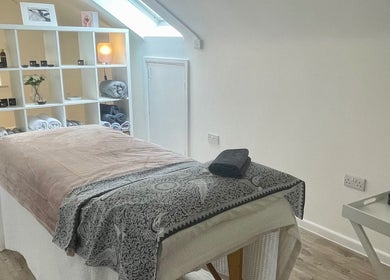 Peaceful spa room at Sarah Emily Holistics, Helpston, England, GB, with massage table and cozy ambiance.