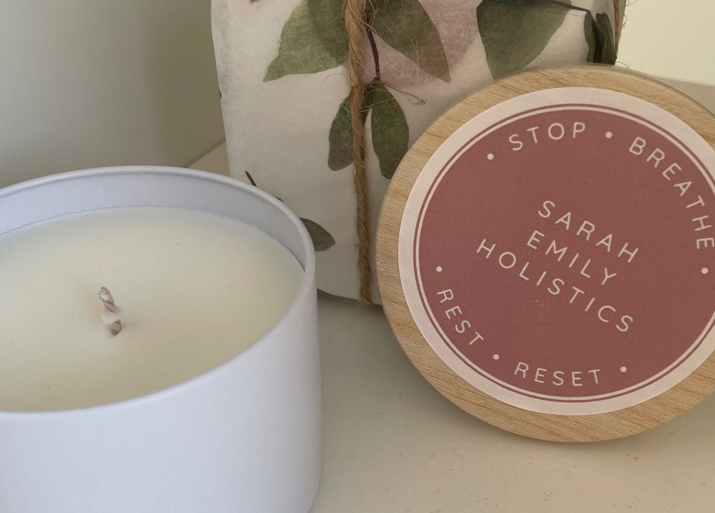 White candle and Sarah Emily Holistics lid at Helpston, England, GB, highlighting relaxation.