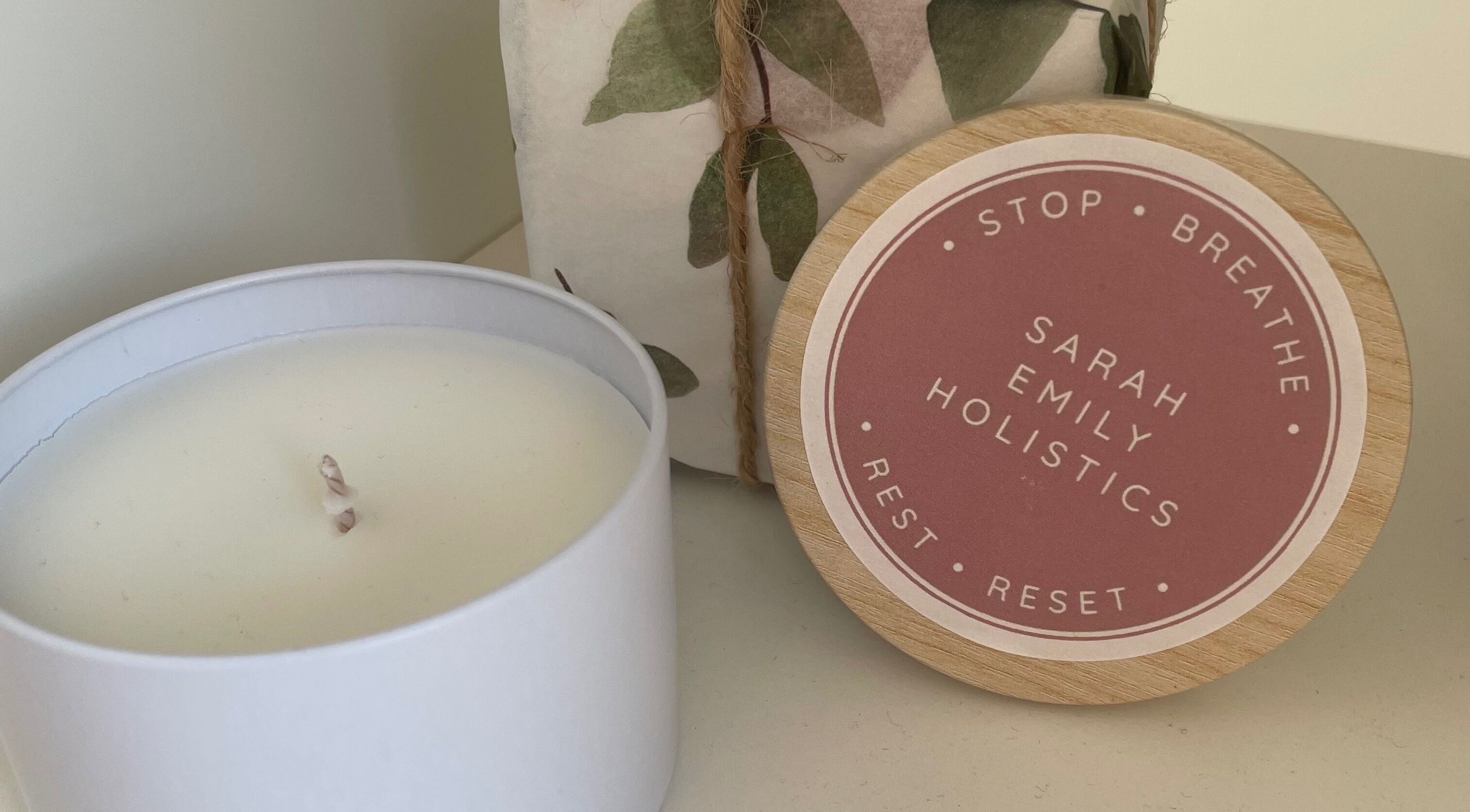 White candle and Sarah Emily Holistics lid at Helpston, England, GB, highlighting relaxation.