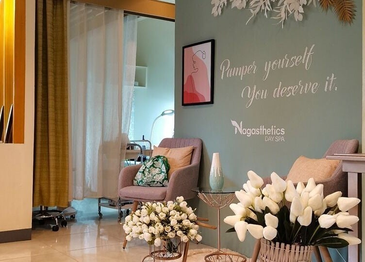 Relaxing seating area at Nagasthetics Day Spa in Naga, Bicol, PH, with cozy chairs and floral decor.