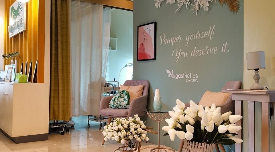 Relaxing seating area at Nagasthetics Day Spa in Naga, Bicol, PH, with cozy chairs and floral decor.