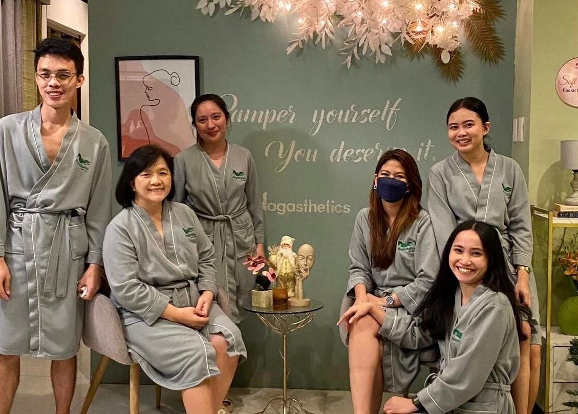 Happy team in robes at Nagasthetics Day Spa, Naga, Bicol, PH, showcasing a serene spa atmosphere.