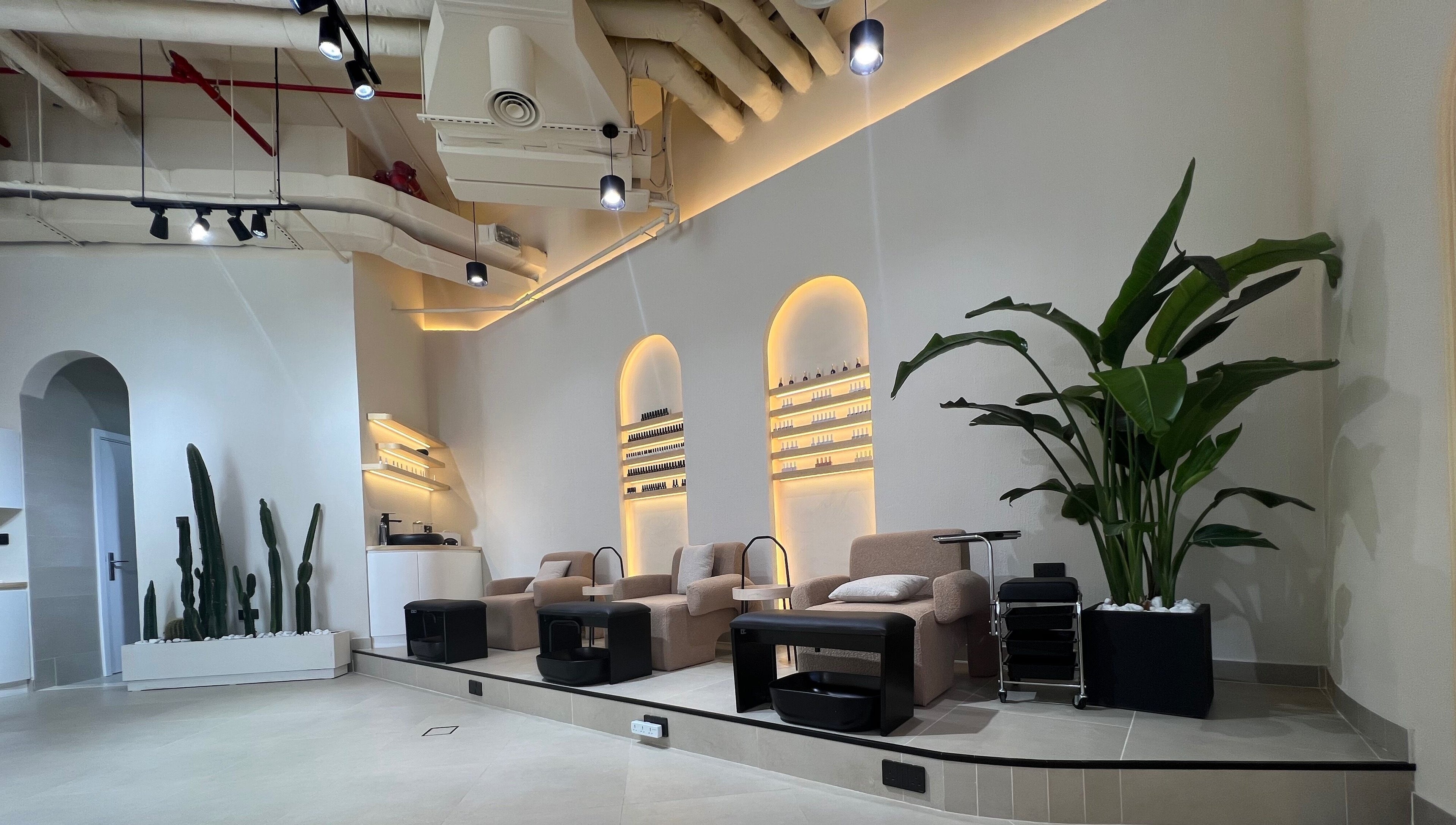Relax in the serene seating area at Xtend Beauty Studio, Dubai, AE, with lush plants and modern decor.