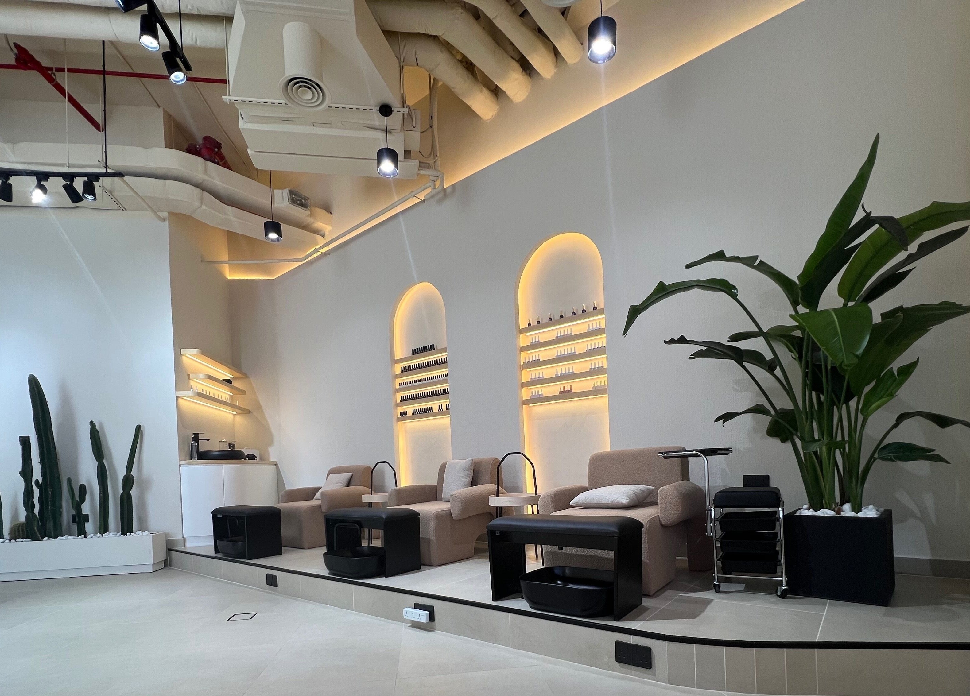 Relax in the serene seating area at Xtend Beauty Studio, Dubai, AE, with lush plants and modern decor.