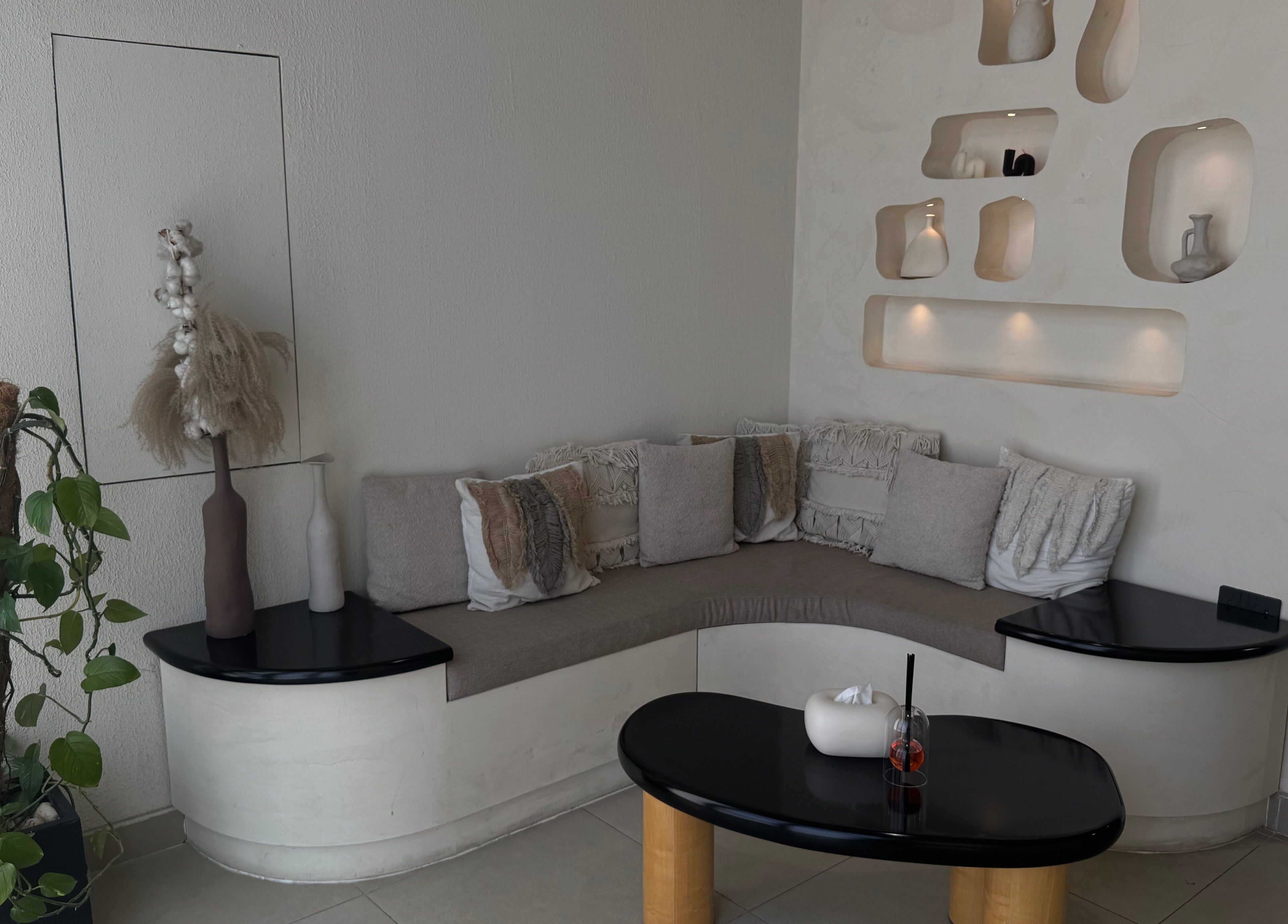 Chic seating area at Xtend Beauty Studio, Dubai, AE with modern decor and plush cushions.