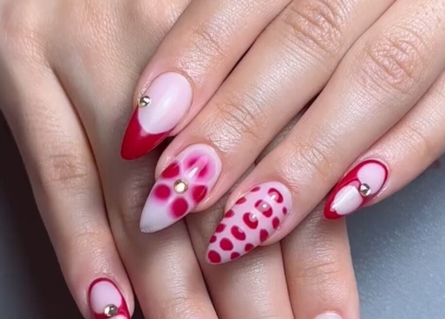 Elegant red and pink nail art design at Xtend Beauty Studio, Dubai, AE, featuring intricate patterns and gems.