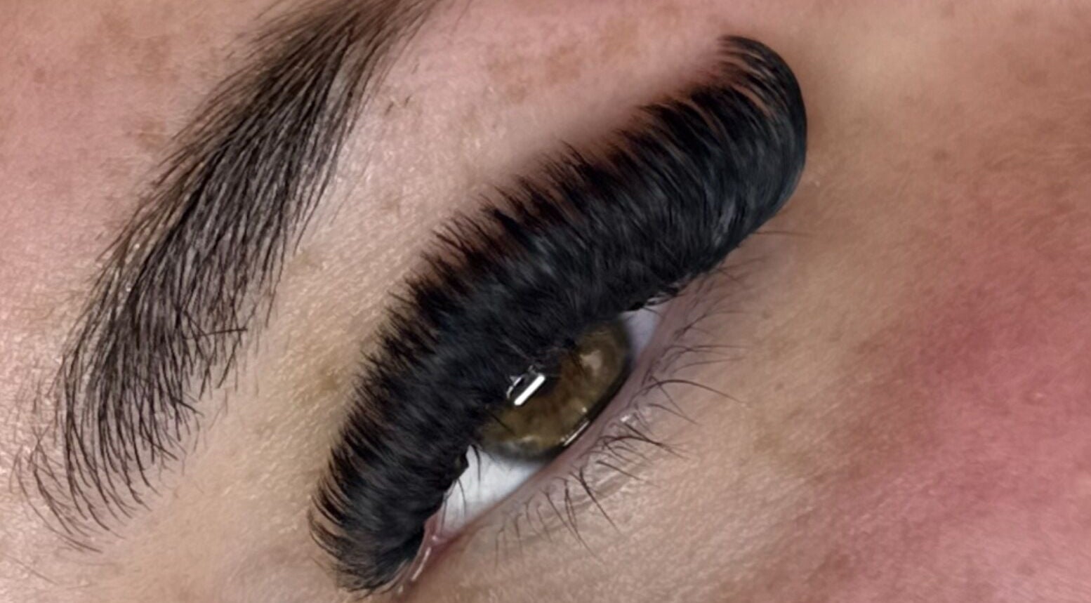Close-up of expertly applied eyelash extensions at Superfine Cosmetics, Ruthin, Wales, GB.
