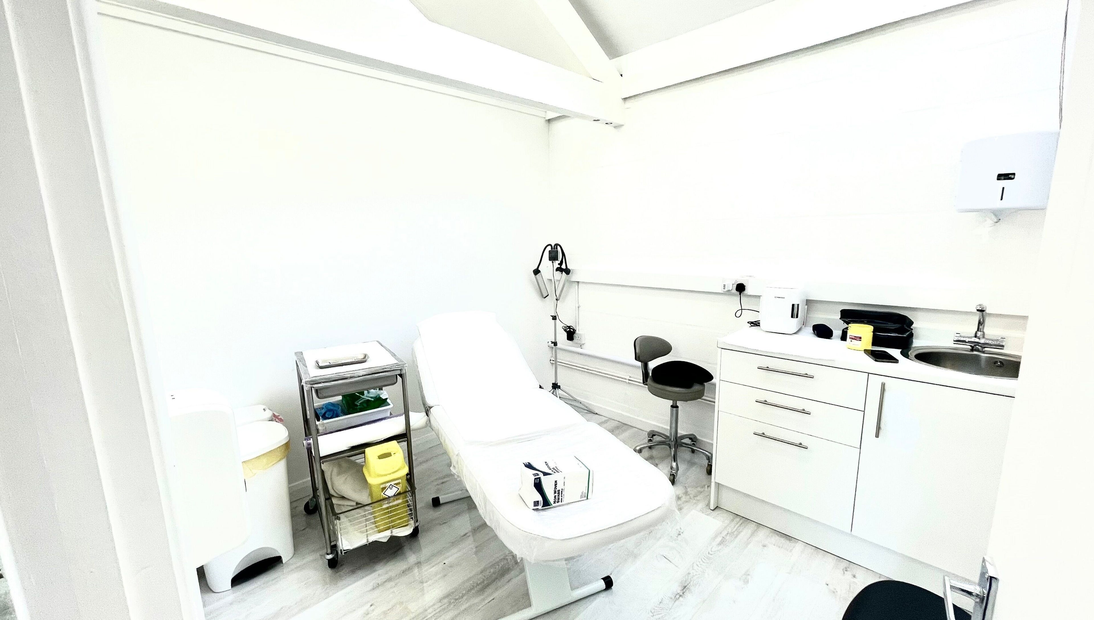 Modern treatment room at Triggs and James Aesthetics, Swansea, Wales, GB, featuring a cozy ambiance.