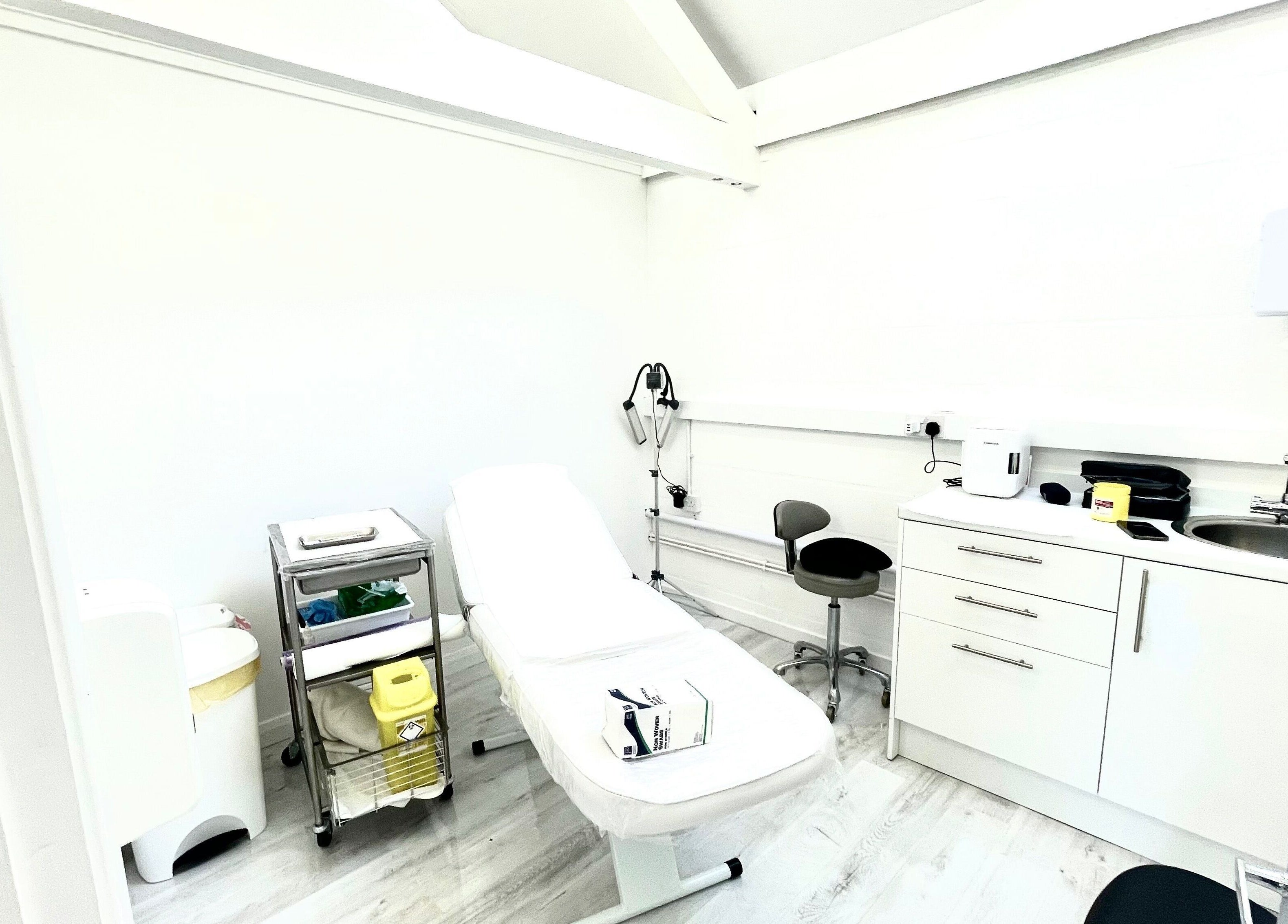 Modern treatment room at Triggs and James Aesthetics, Swansea, Wales, GB, featuring a cozy ambiance.
