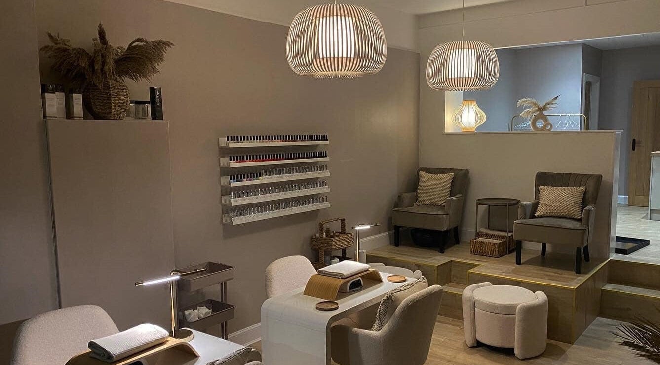 Elegant interior of Twelve Beauty Co., Edinburgh, Scotland, GB, featuring plush seating and nail polish display.