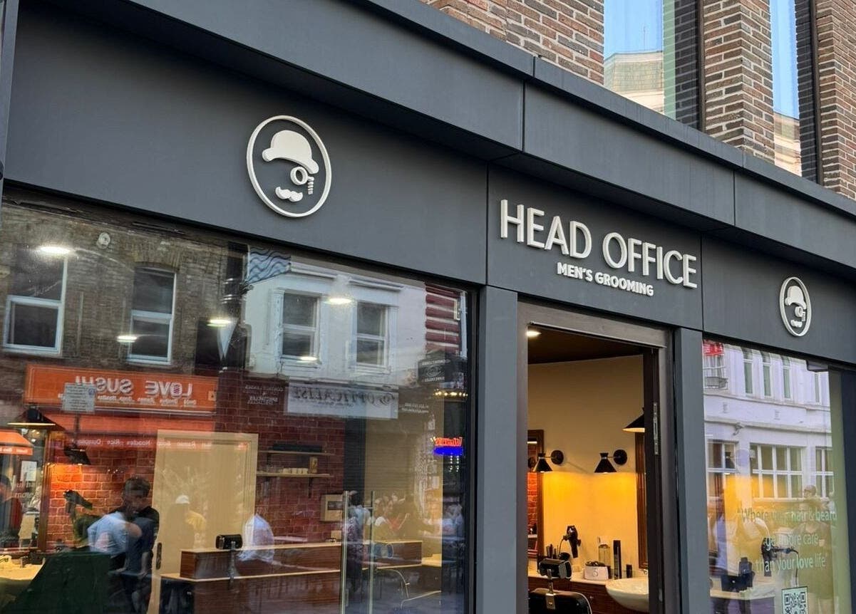Front view of Head Office Men's Grooming - Waterloo in London, England, GB with a classic barber pole.