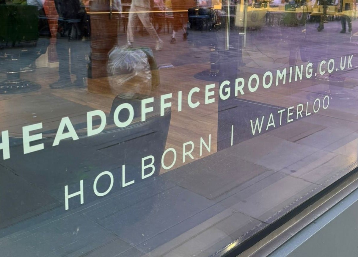 Window display of Head Office Men's Grooming - Waterloo, London, England, GB, showing stylish interior.