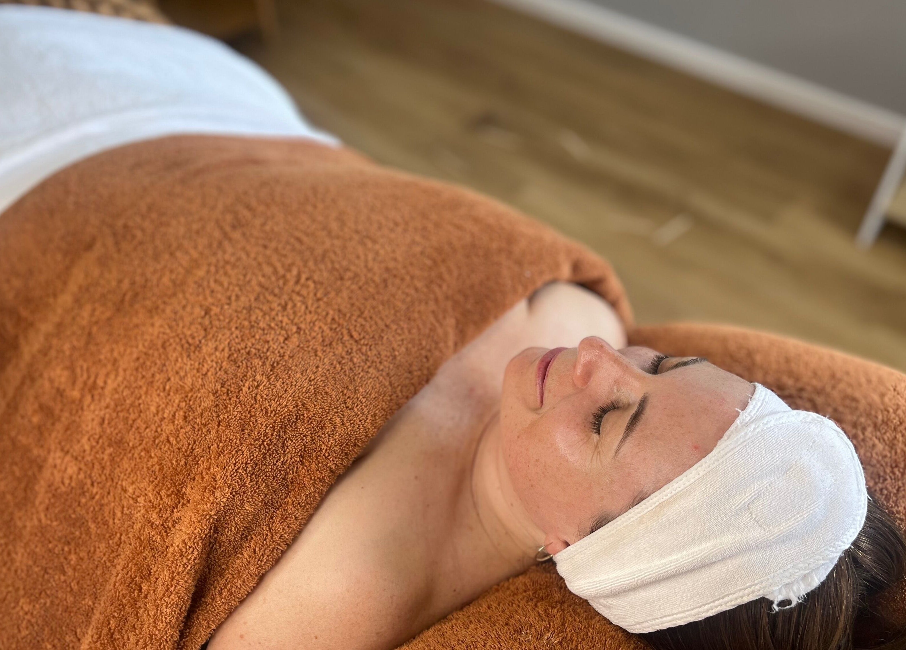 Relaxing facial treatment at Skin Solace, Blackwood, Victoria, AU. Woman resting with towel wrap.