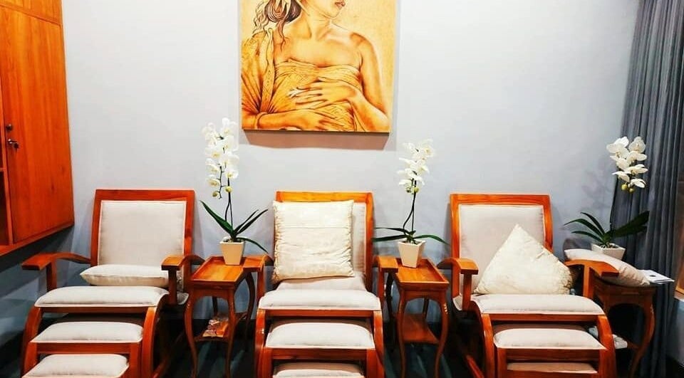 Cozy seating area in Peni Weni, Bali, Bali, ID with elegant wooden chairs and lush orchids.