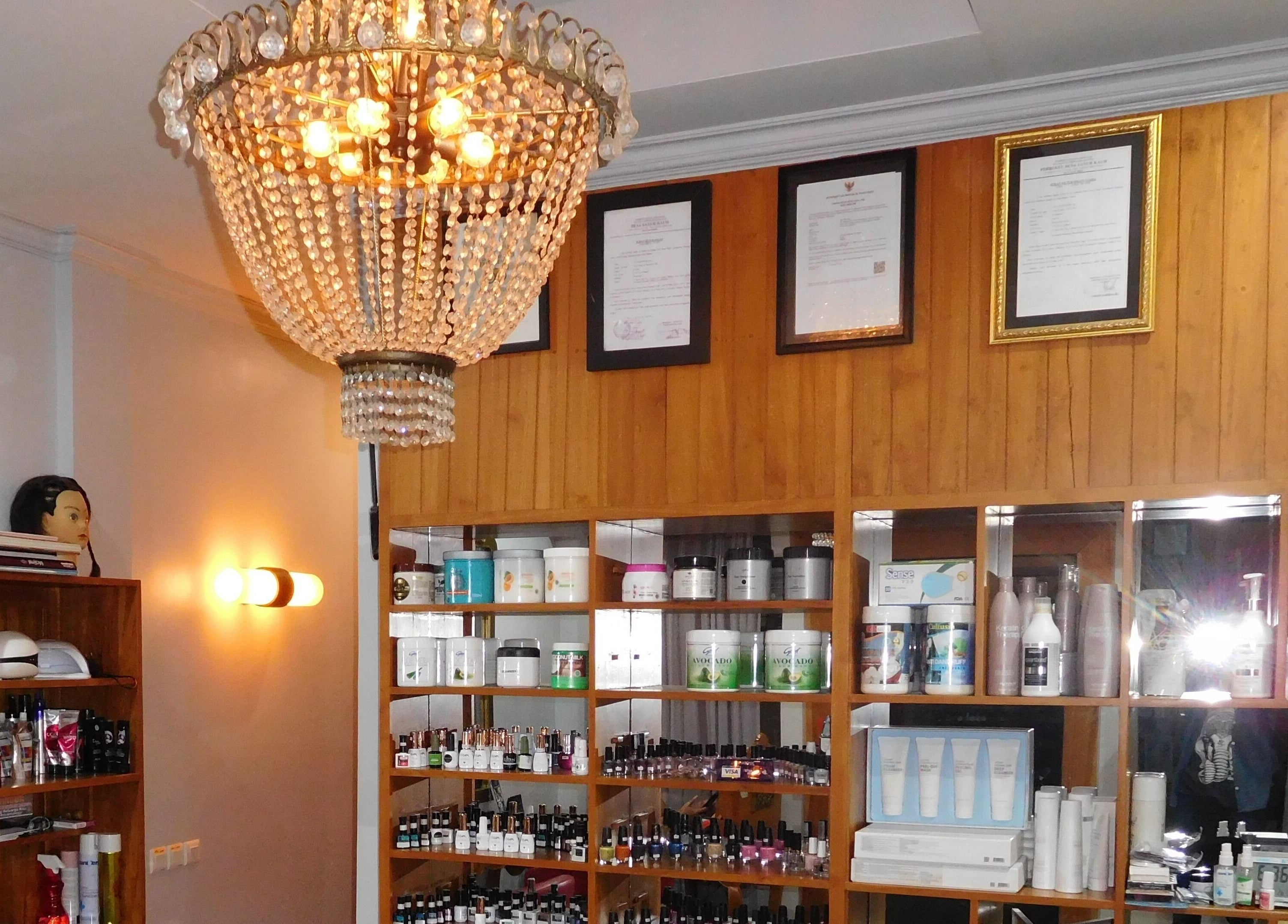 Elegant chandelier illuminating beauty products at Peni Weni, Bali, Bali, ID.