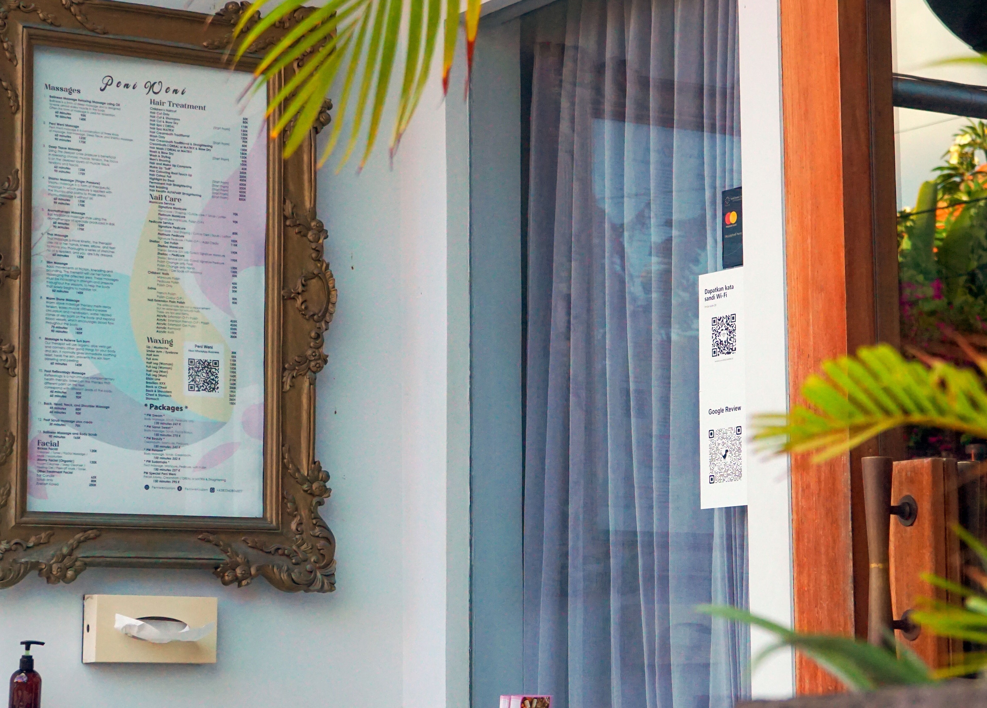 Framed service menu at Peni Weni, Bali, Bali, ID showcasing available beauty treatments.
