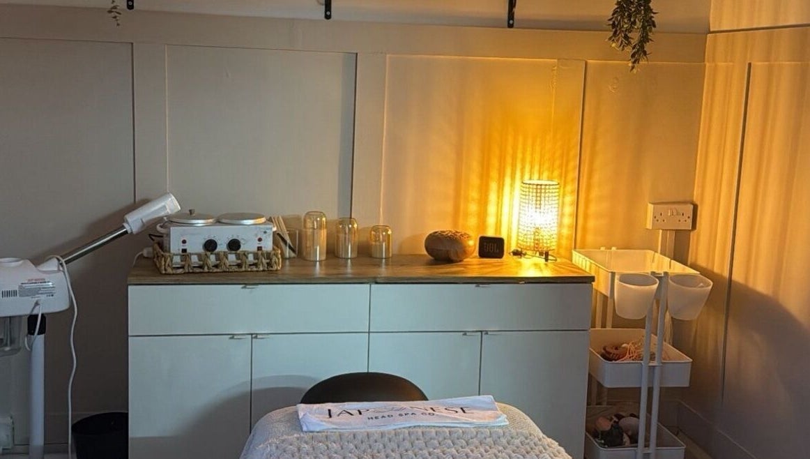 A warmly lit treatment room at Skin Perfected Ferring, Ferring, England, GB showcasing a tranquil atmosphere.